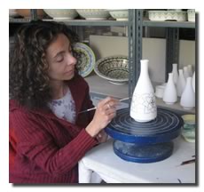 Paola painting a vase
